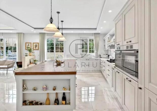 A bright, modern kitchen with white cabinetry, a c