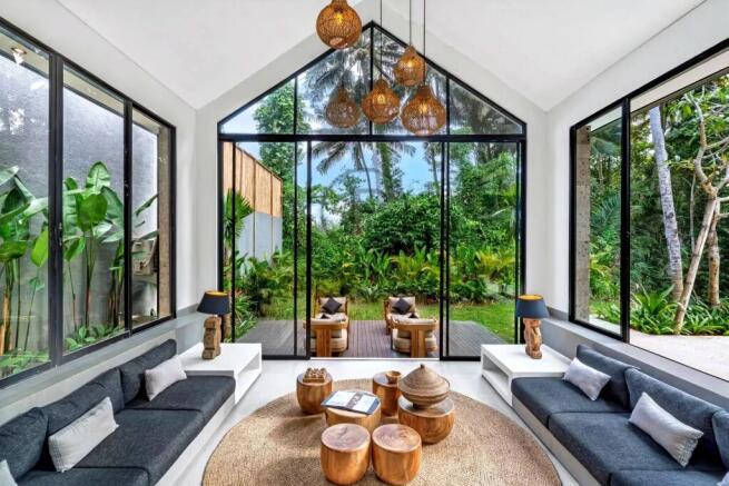 A modern living space features large glass windows