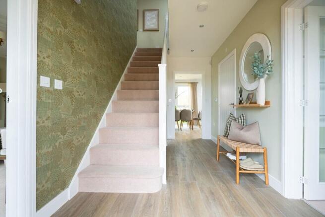 The central entrance hall is welcoming with space for fitted understairs storage