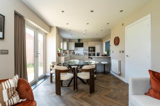 The dining area flows into the garden through double doors