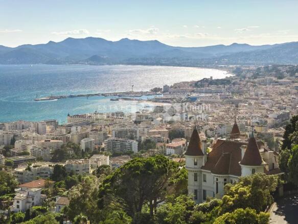 A scenic view of a coastal city with a castle-like