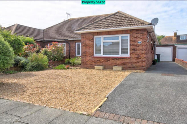 Front facia, gravel driveway, garage entrance 
