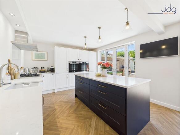Shaker-style kitchen with integrated appliances and twin sets of French Doors