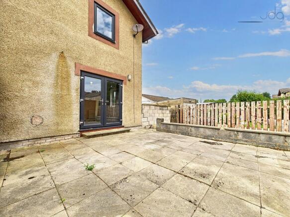 Flagged garden that wraps around the rear of the property