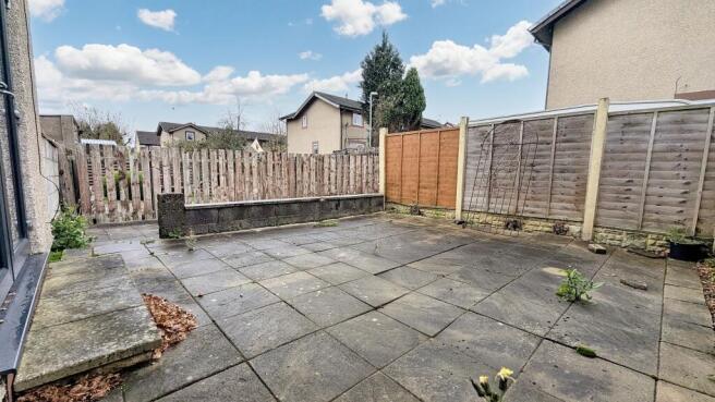 Flagged garden that wraps around the rear of the property
