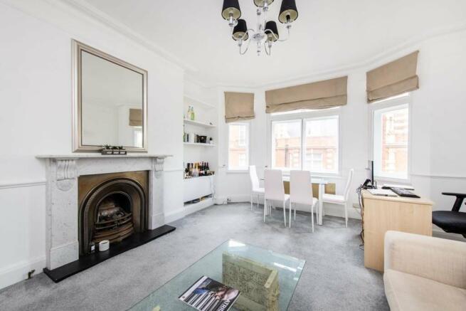 High ceilings & period fireplace in reception room