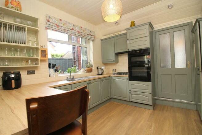 Sage green kitchen in a renovated Victorian home, Southport