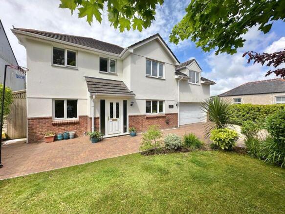 Front with brick paved drive and encl...