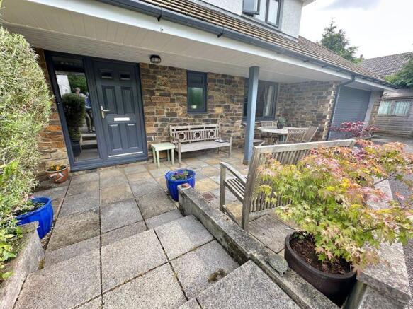 Attractive covered entrance and natur...
