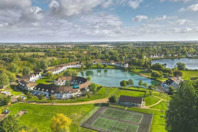 Aerial view of lodge, tennis courts a...