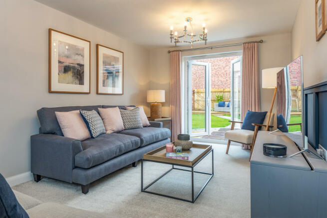 Spacious lounge with French doors to the garden in the Alderney 4 bedroom home