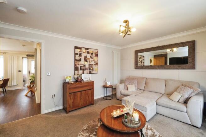 Spacious yet Cosy Living Room with French Doors and Feature Media Wall and Fire