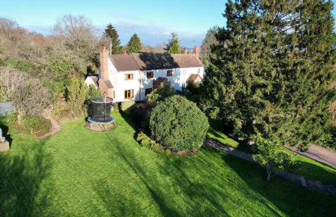 With mature trees and lawn garden