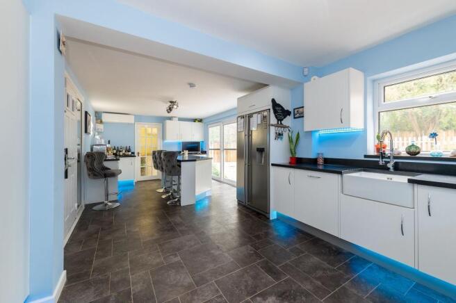 Large open plan white kitchen