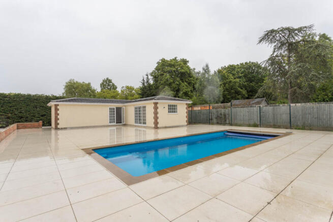 Swimming Pool with large paved patio area