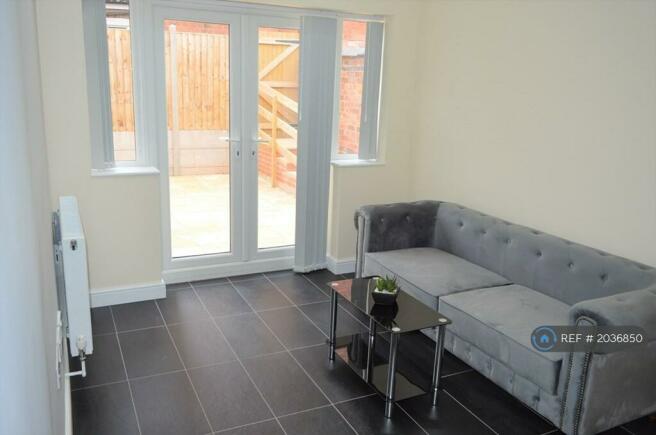 Open Plan Lounge With Doors Leading To Rear Garden
