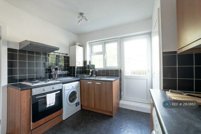  Kitchen With Washing Machine And Gas Cooker  