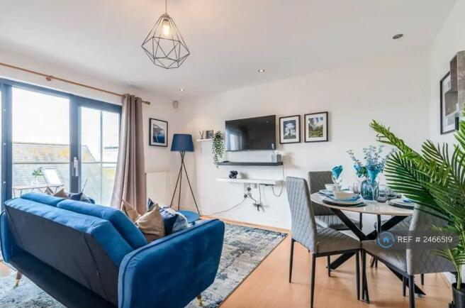 Beautifully Decorated Living Room With Balcony.