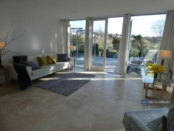 Living Room Leading To Front Patio/Balcony Area