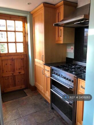Kitchen With Fridge And Cooker