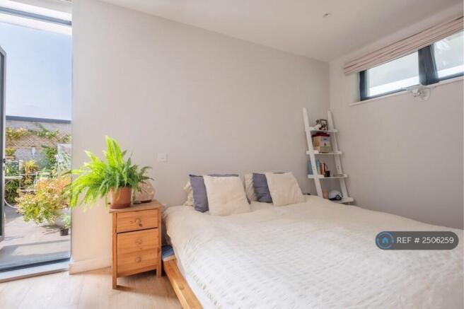 Bedroom With Open Door To Balcony