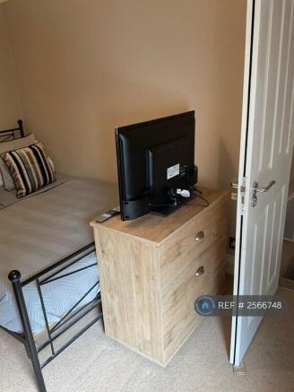 There Is a Tv,  Chest Of Drawers And Wardrobe