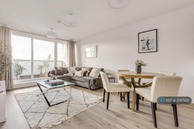Living & Dining Room With Sunset Balcony Views