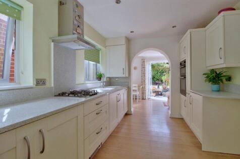 Shaker kitchen leads to sunny breakfast room