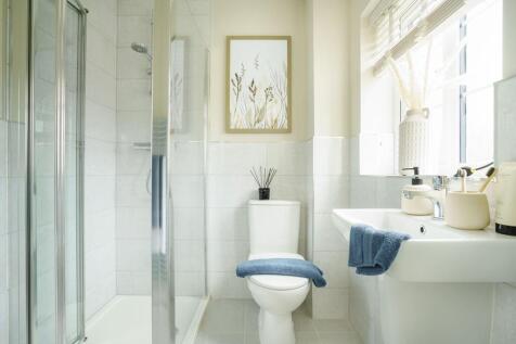 The en-suite benefits from a large double shower
