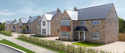 Modern new-build houses with brick facades, large bay windows, and neatly maintained front gardens o