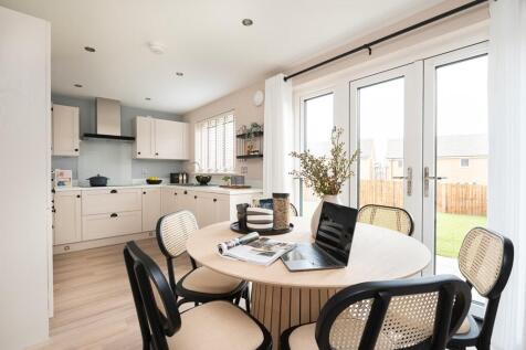 A modern kitchen and dining area with French doors to the rear garden