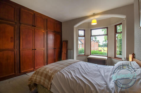 Main bedroom with bank of fitted wardrobes &amp; perio