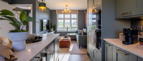 Modern living room with a large window, grey walls, sofa, and contemporary decor seen from the kitch