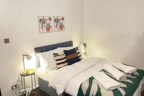 A stylish and inviting double bedroom featuring...