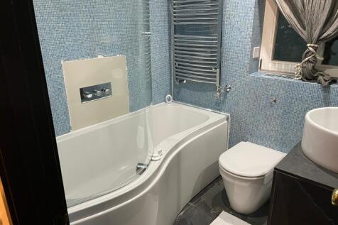 A beautifully designed large bathroom featuring...