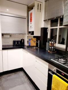 A modern and tidy kitchenette featuring sleek c...