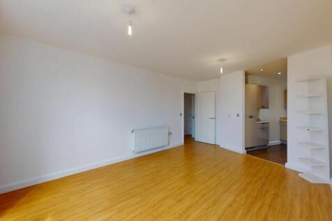 A bright and spacious living room featuring cle...