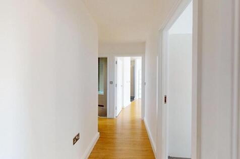 Bright and clean hallway with light wooden floo...