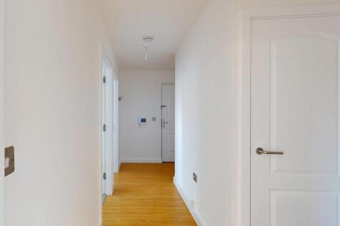 A clean and well-maintained hallway with white ...