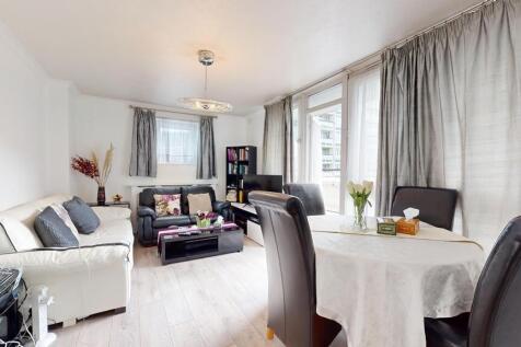 A spacious and well-lit living room featuring a...