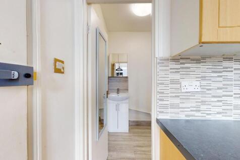 A clean, well-maintained bathroom with a sink a...