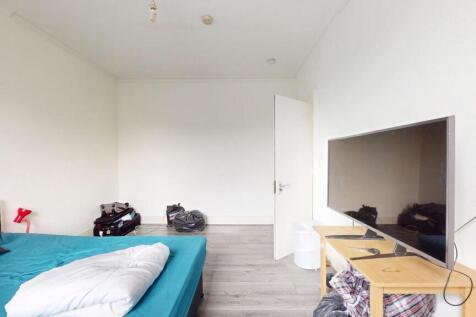 Bright and spacious master bedroom featuring a ...