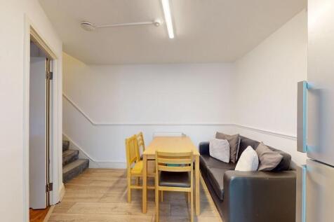 Bright, simply furnished living/dining area wit...