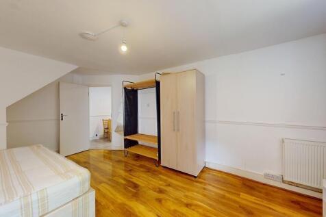 Bright, tidy bedroom with wood-effect flooring,...