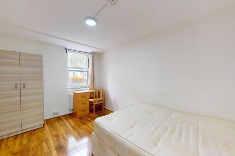Bright, simply furnished single bedroom with a ...