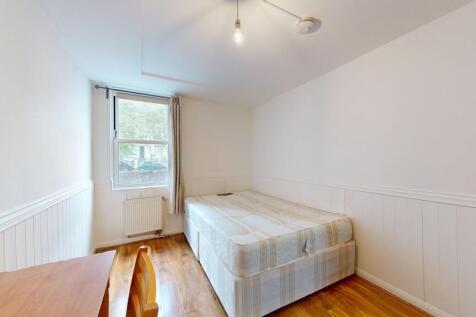 Bright, simply styled bedroom with a comfortabl...