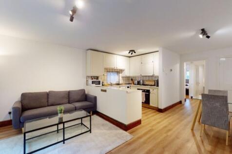 Bright open-plan living and kitchen area with m...