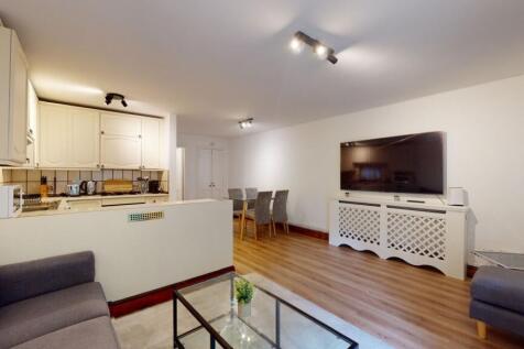 Bright, modern open-plan living area with a com...