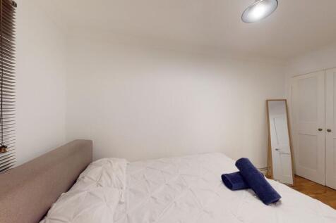 Fresh, simply styled double bedroom with a neut...