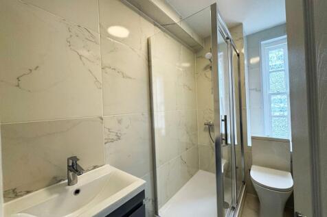 Bright, modern bathroom with a walk-in shower, ...